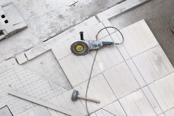 Construction tools on sidewalk under repair. Construction background